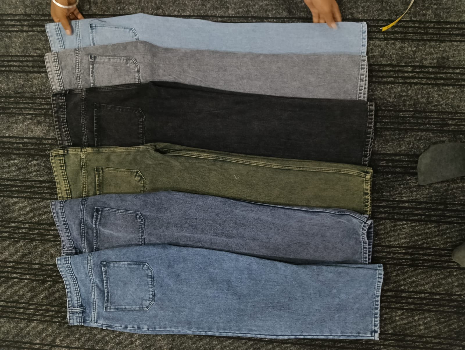 Folded Rai-ox jeans in multiple colours laid out