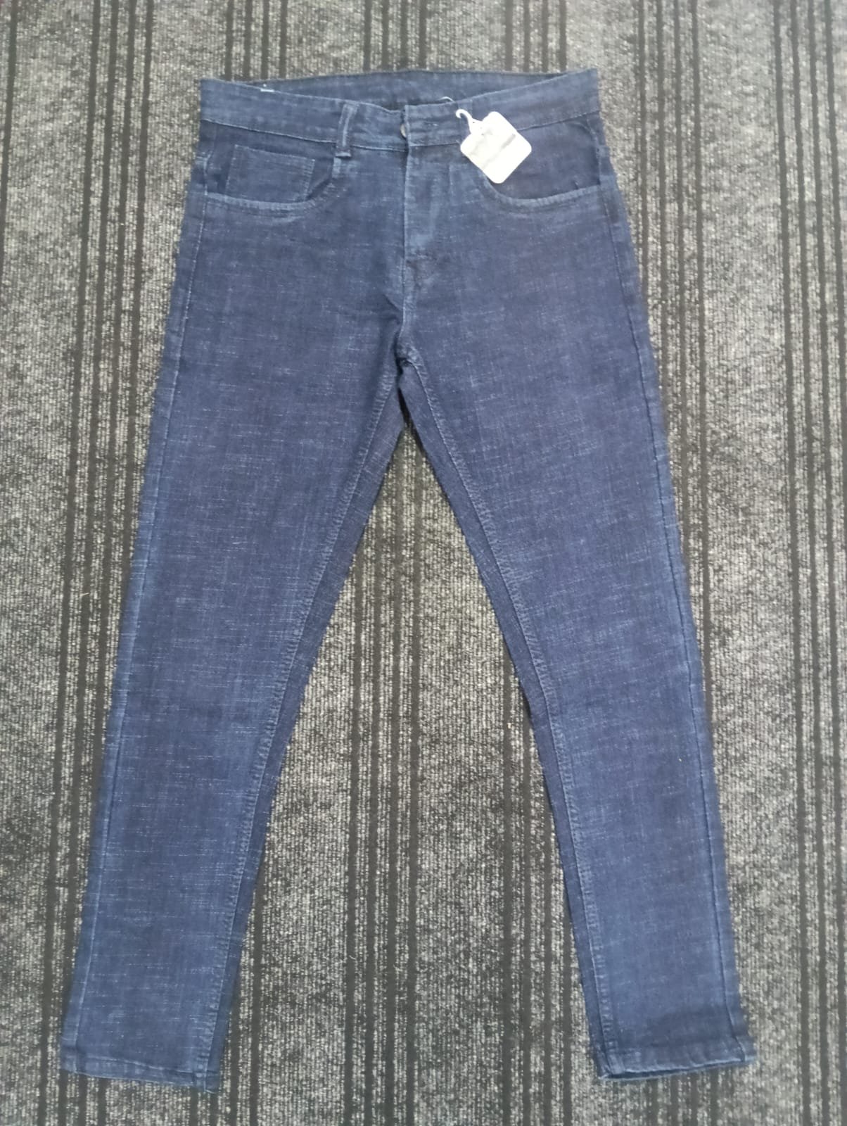 Flat lay of dark indigo Rai-ox slim jeans